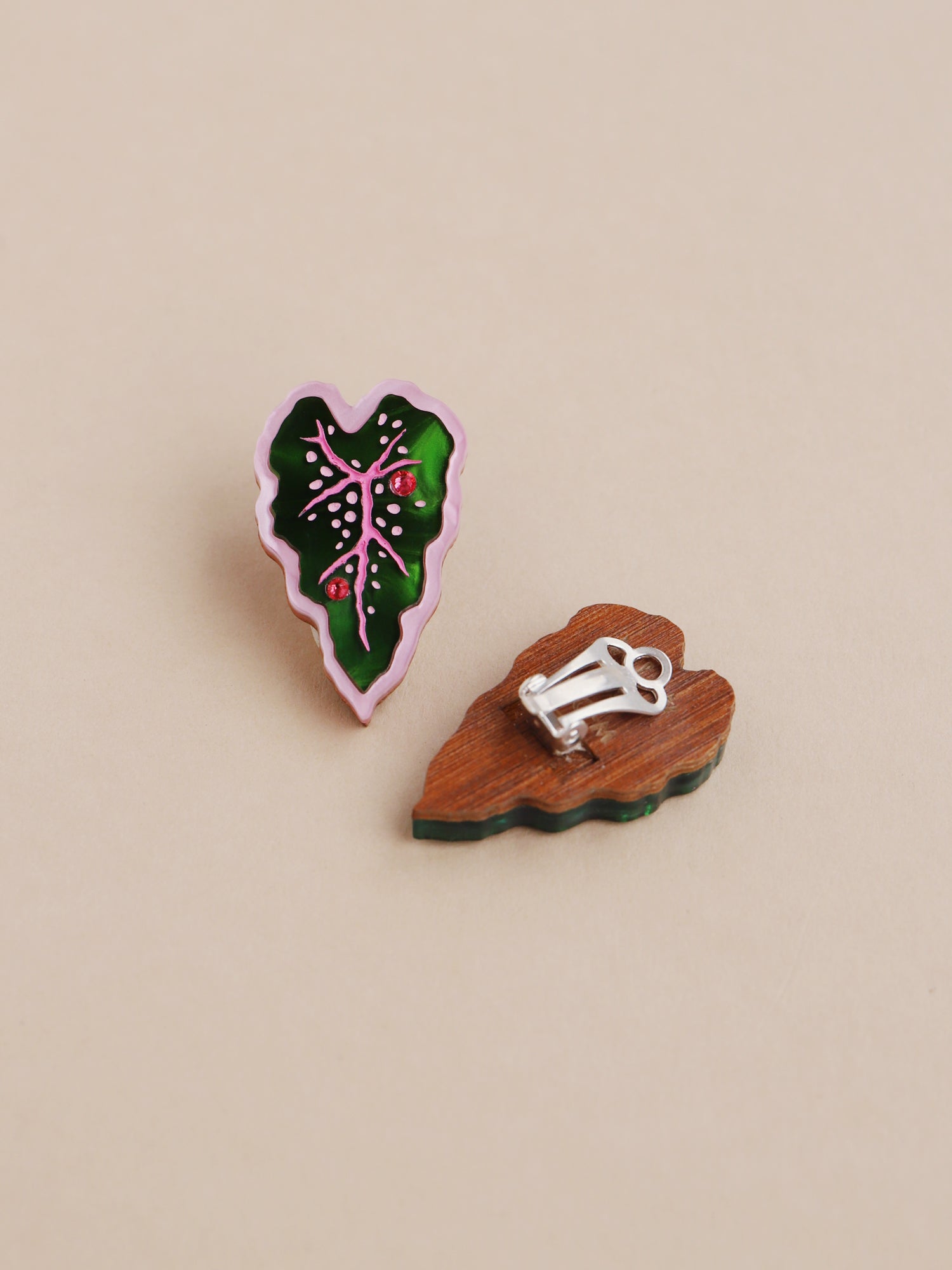 Heart-shaped caladium leaf clip-on earrings. A design collaboration with L.O.M, a colourful party-wear brand. Handmade in the UK by Wolf & Moon.