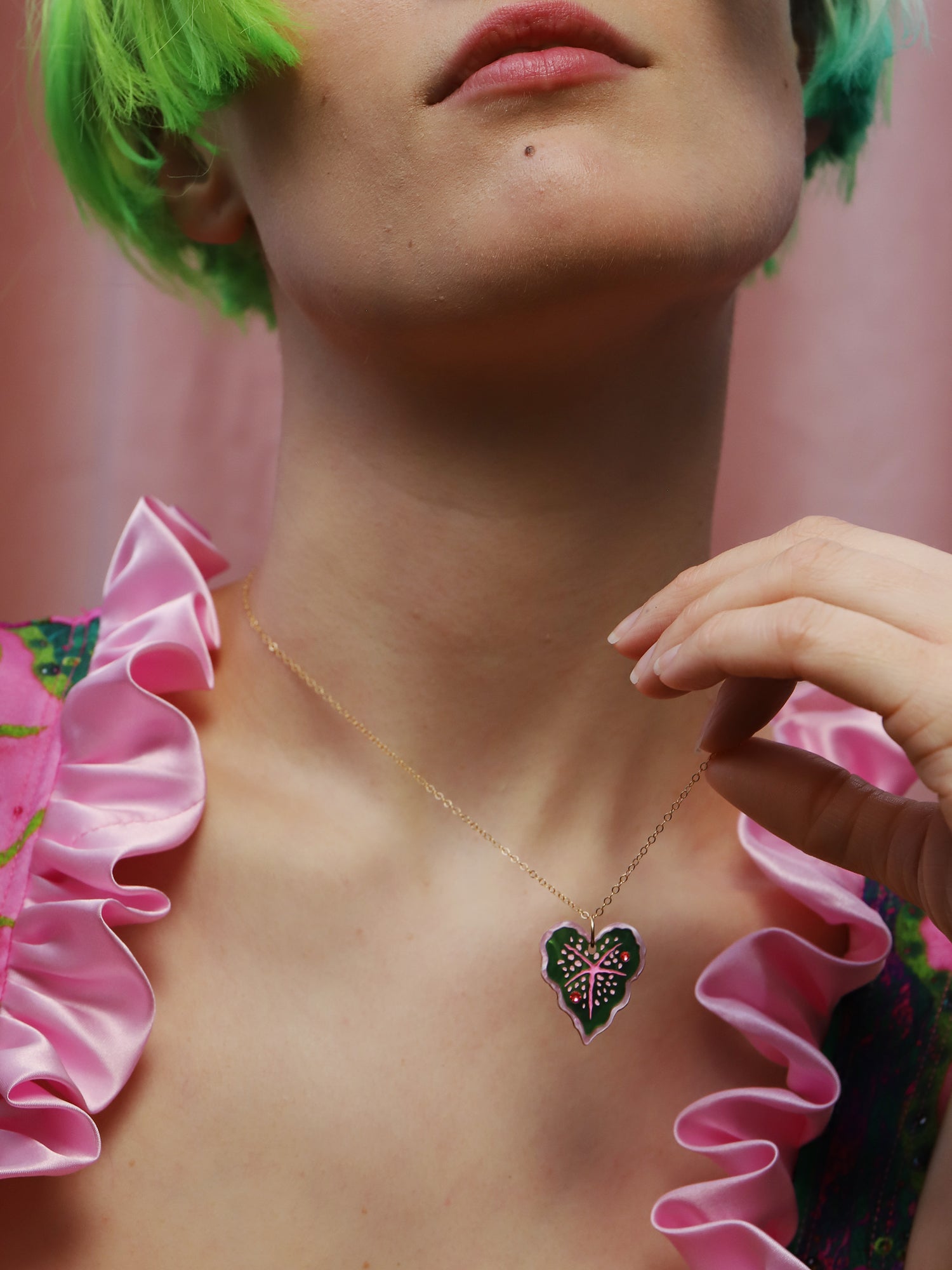 Heart-shaped caladium leaf necklace. A design collaboration with L.O.M, a colourful party-wear brand. Handmade in the UK by Wolf & Moon.