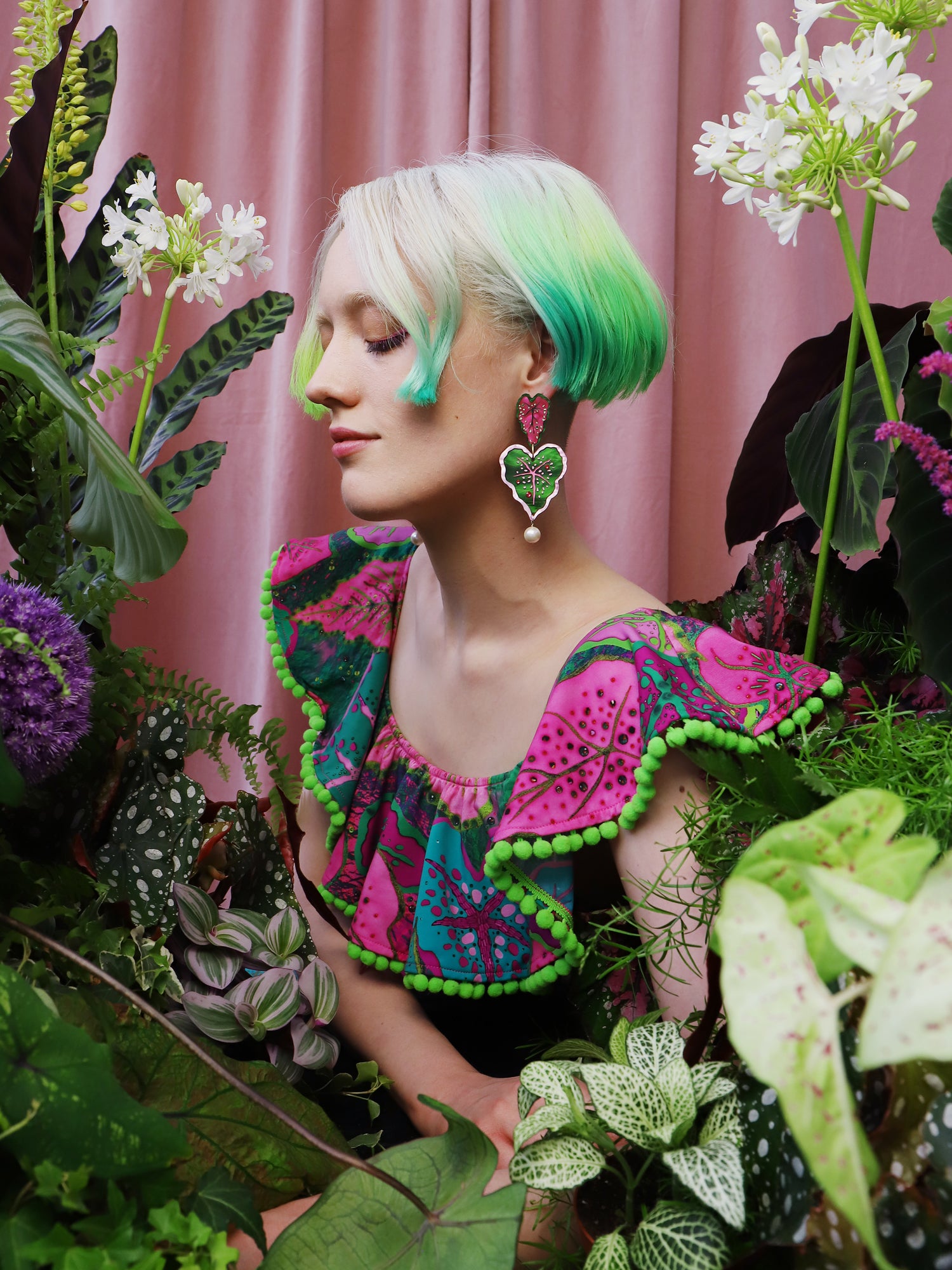 Heart-shaped caladium leaf statement earrings. A design collaboration with L.O.M, a colourful party-wear brand. Handmade in the UK by Wolf & Moon.