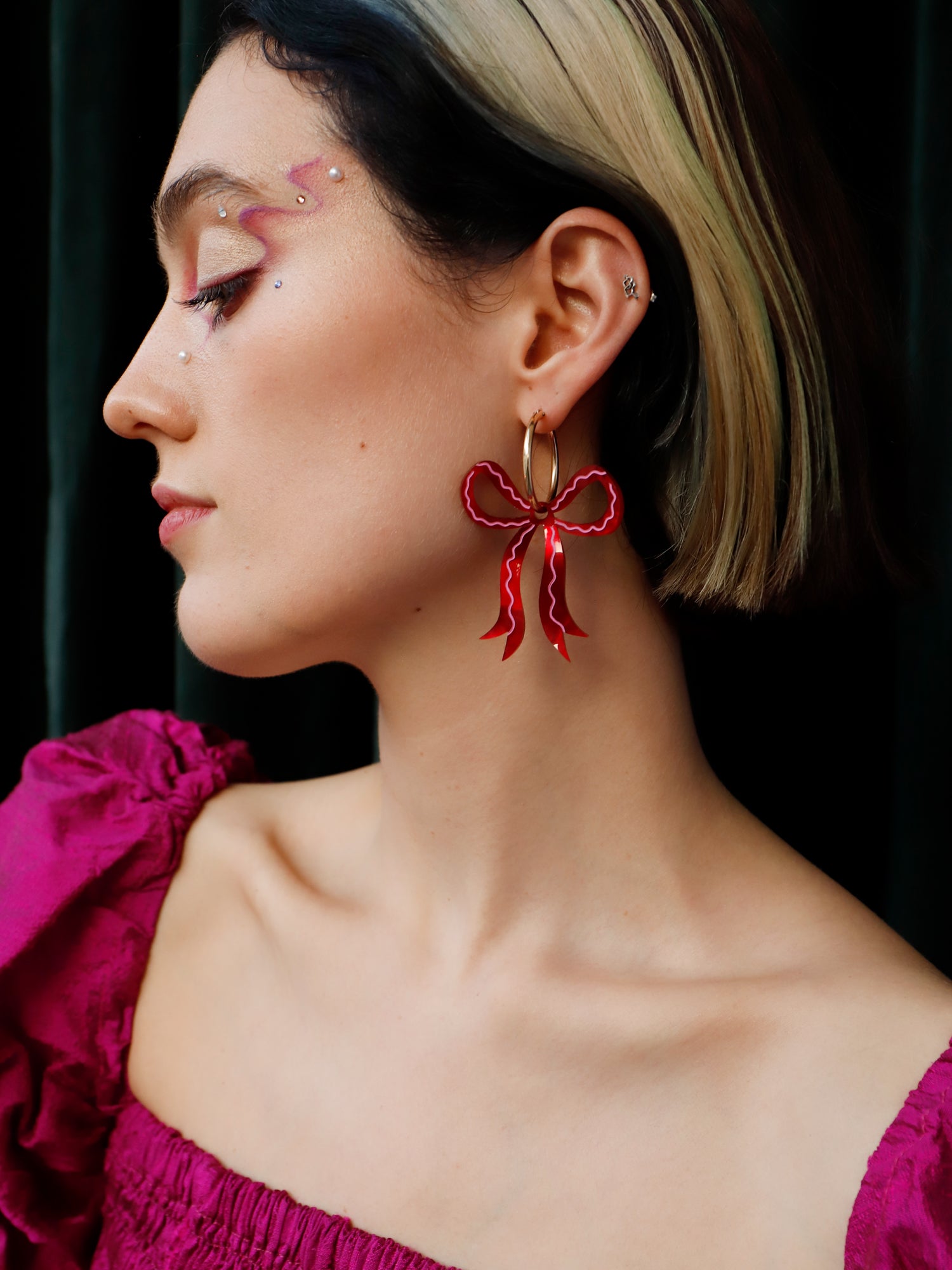 Bow hoop earrings made from red marbled acrylic with hand-inked details. Finished off with high quality glass pearls and 14k gold-filled findings. Each bow is hand-sculpted into a 3D form giving it a lovely realistic ribbon-like effect. Handmade in London by Wolf & Moon.