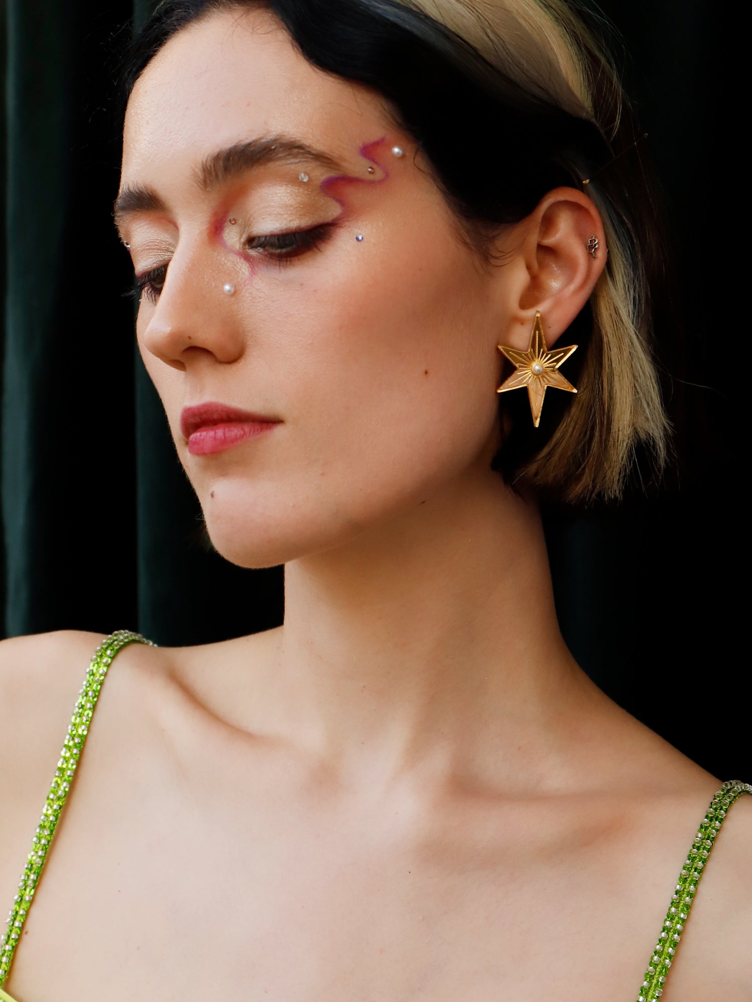 Statement star studs made with gold mirrored acrylic, embellished with glass pearls and hand inked details. Handmade in London by Wolf & Moon.